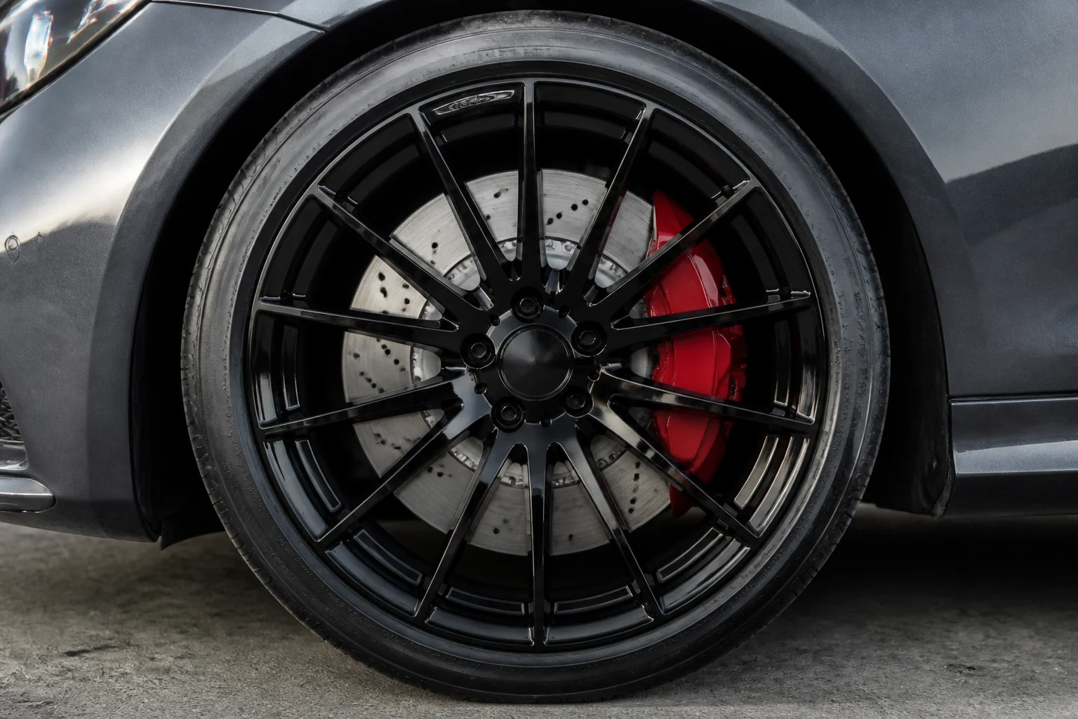 Same-angle wheel and tire after a Blackline demo clean (fictional demo imagery)