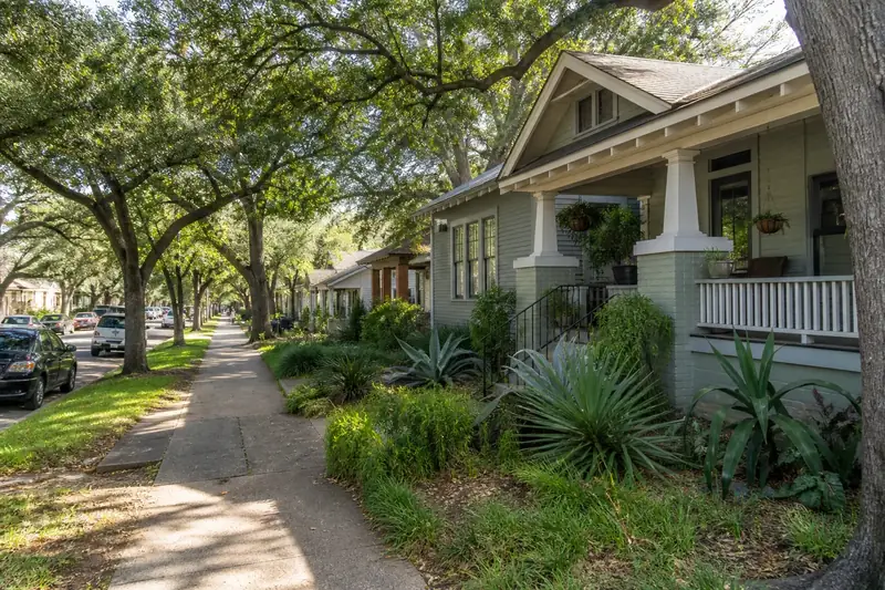 Tree-lined Travis Heights street with porch-front homes
